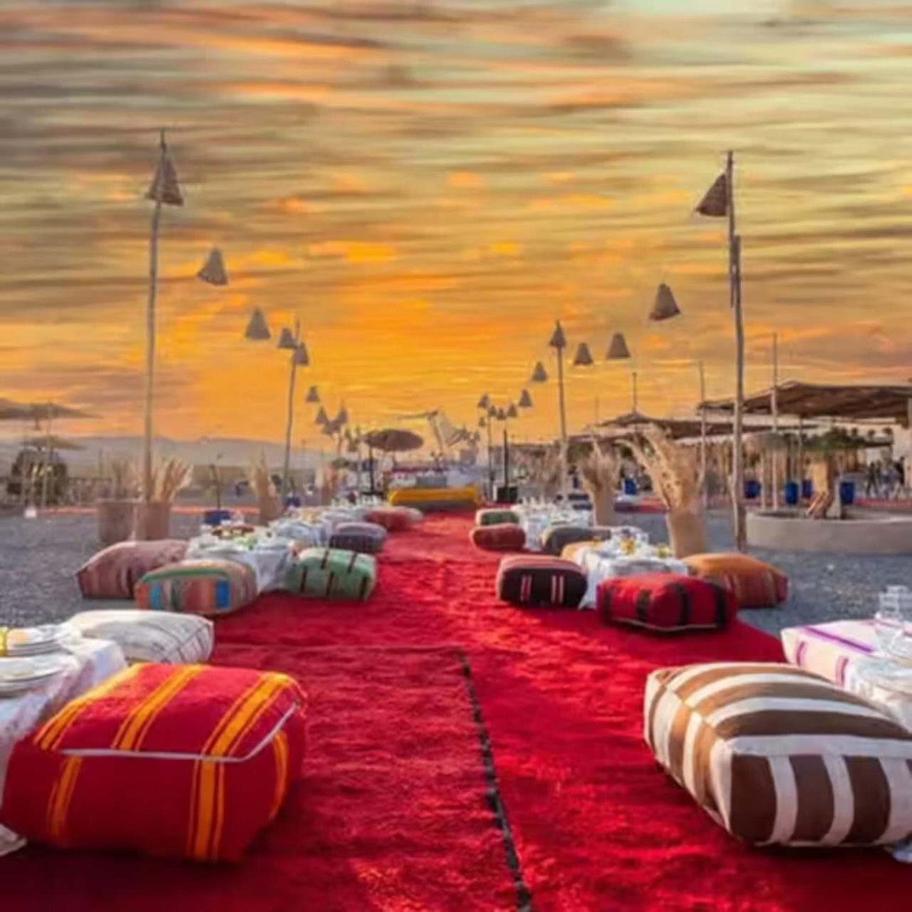 A desert camp with traditional cushions at sunset