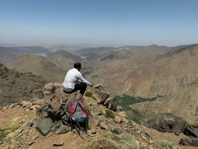 A hiker looking over a dry mountain valley