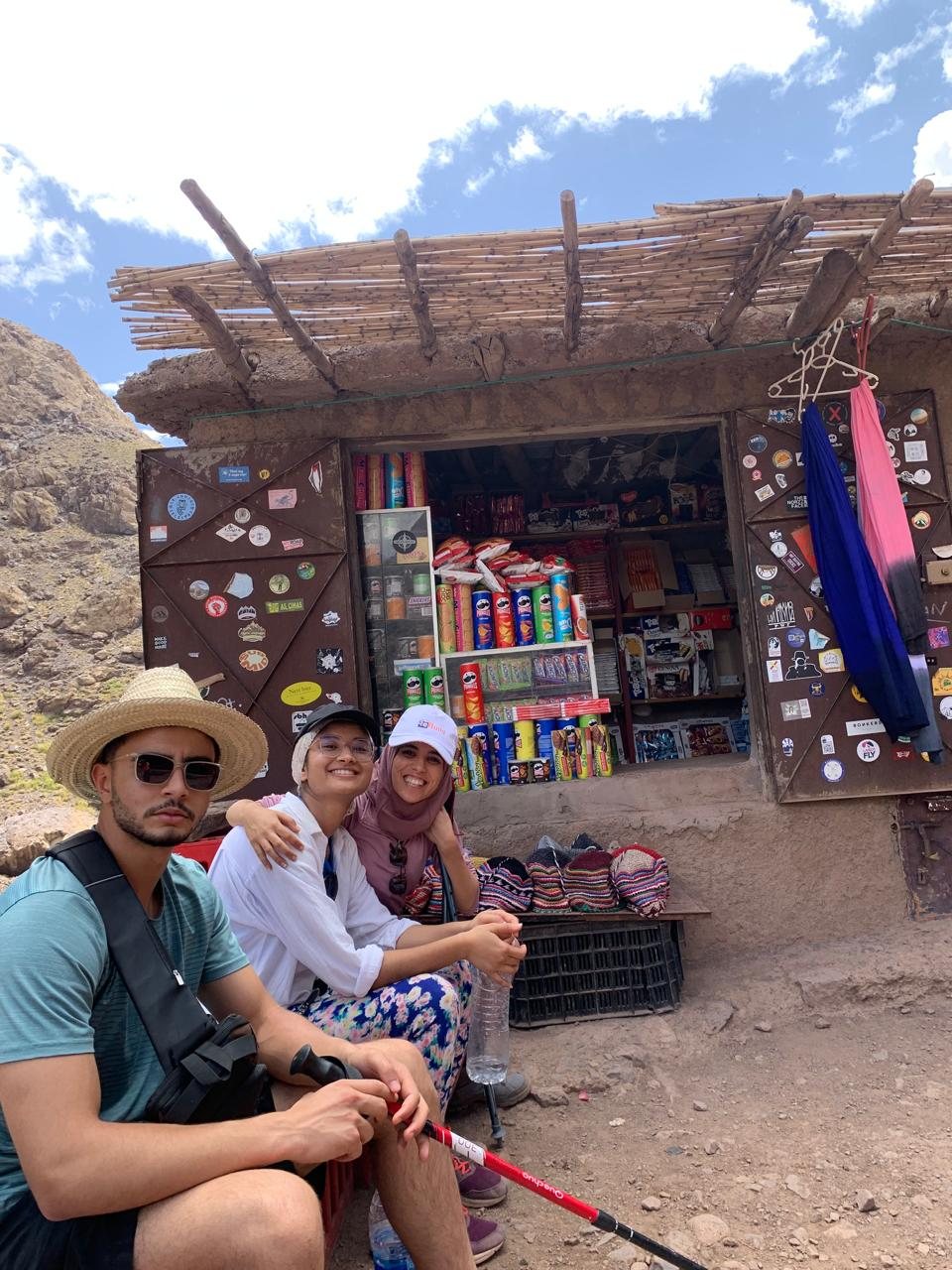 Travellers resting outside a small mountain shop