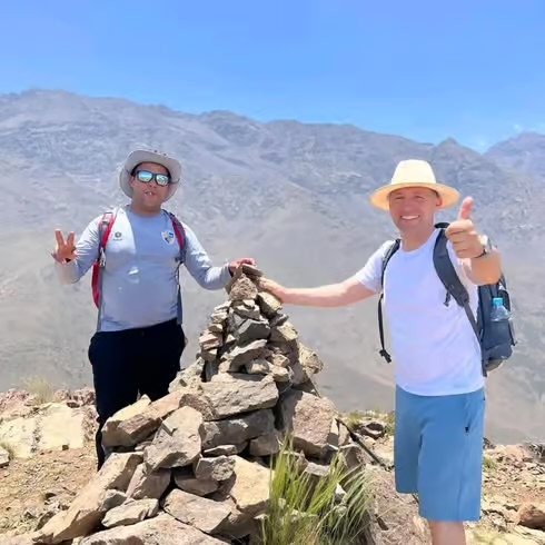 Two hikers taking a break on a mountain ridge