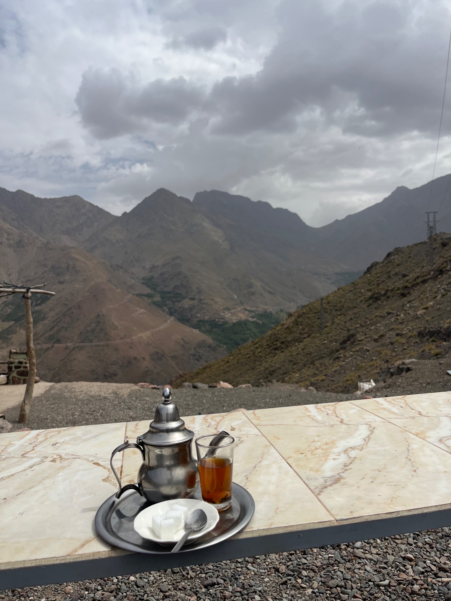 A tea set overlooking a mountain valley