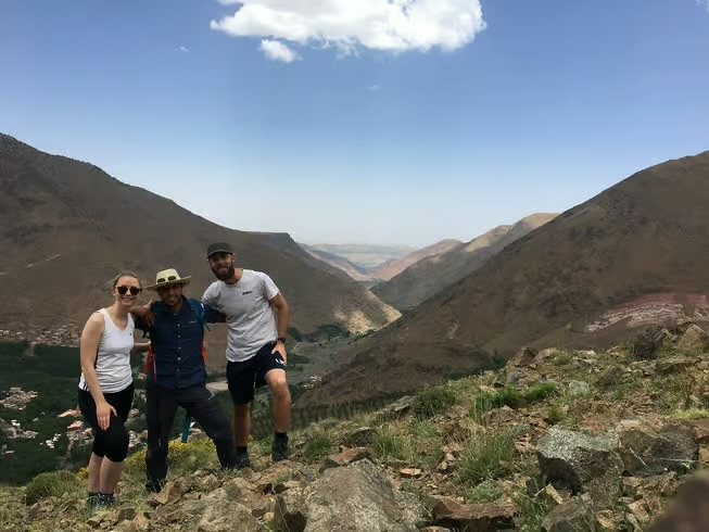 Travellers posing with a local guide in the High Atlas