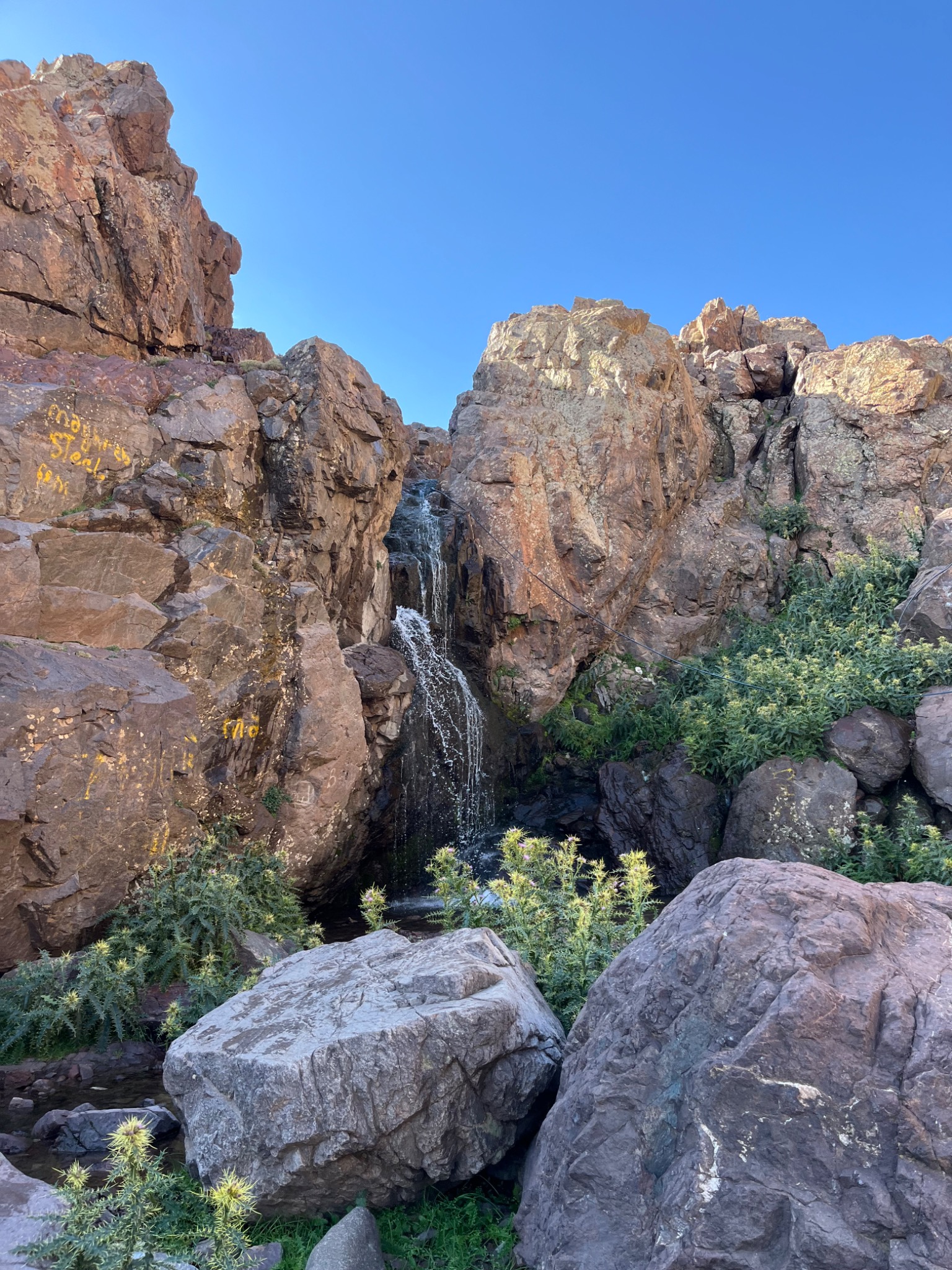 A small waterfall between mountain rocks