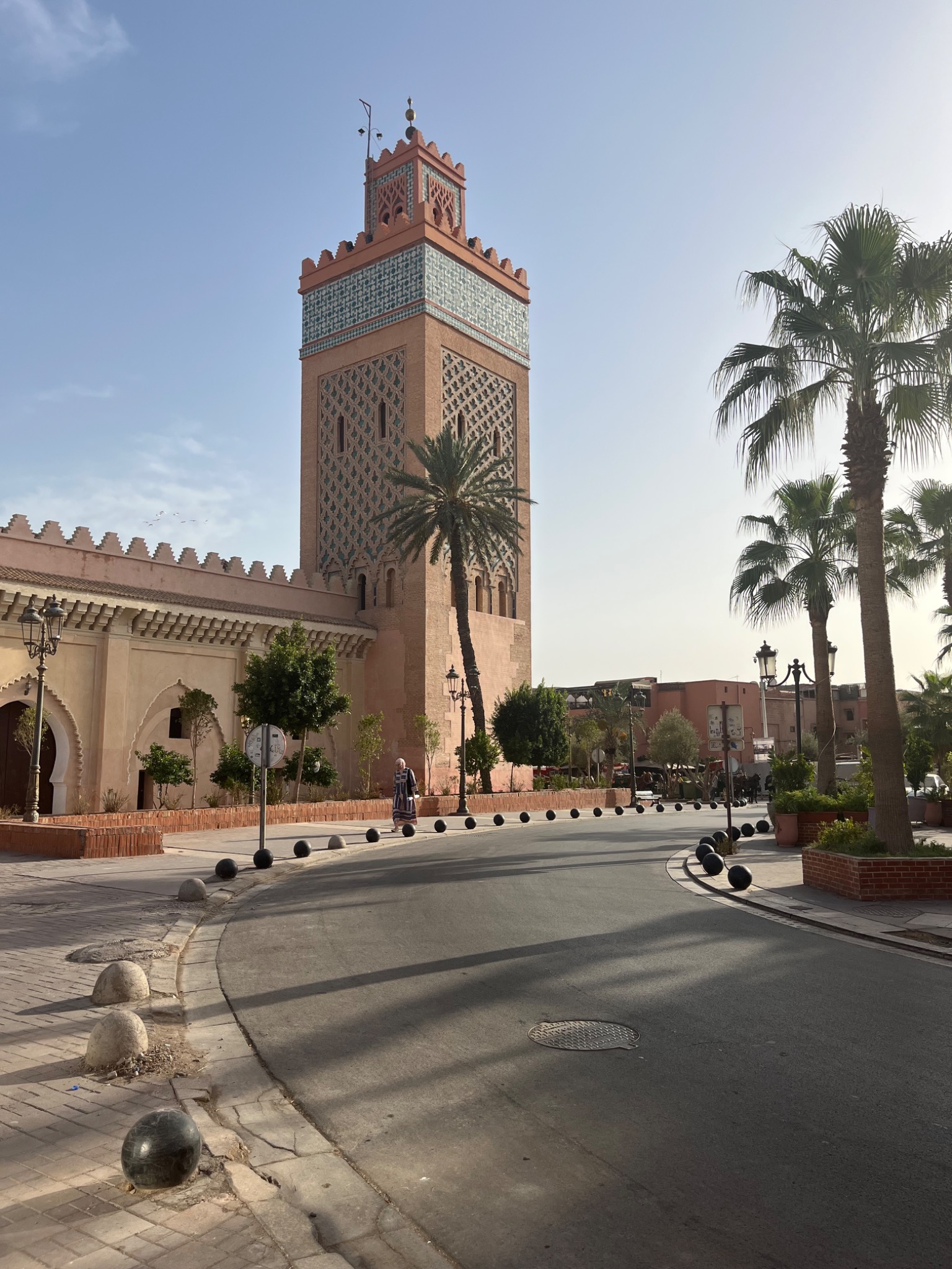 A mosque minaret and palm trees in Marrakech