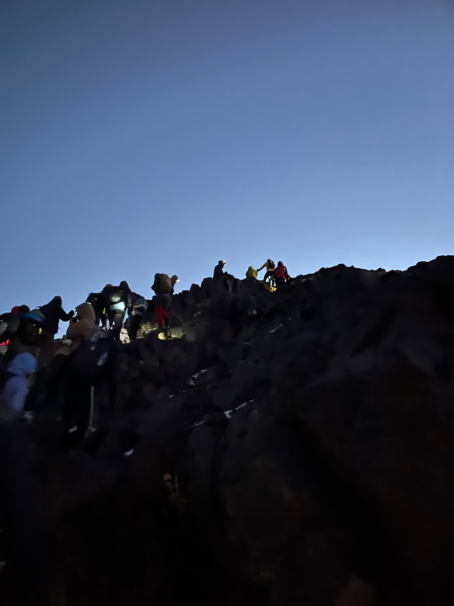 Hikers climbing in the dark before sunrise