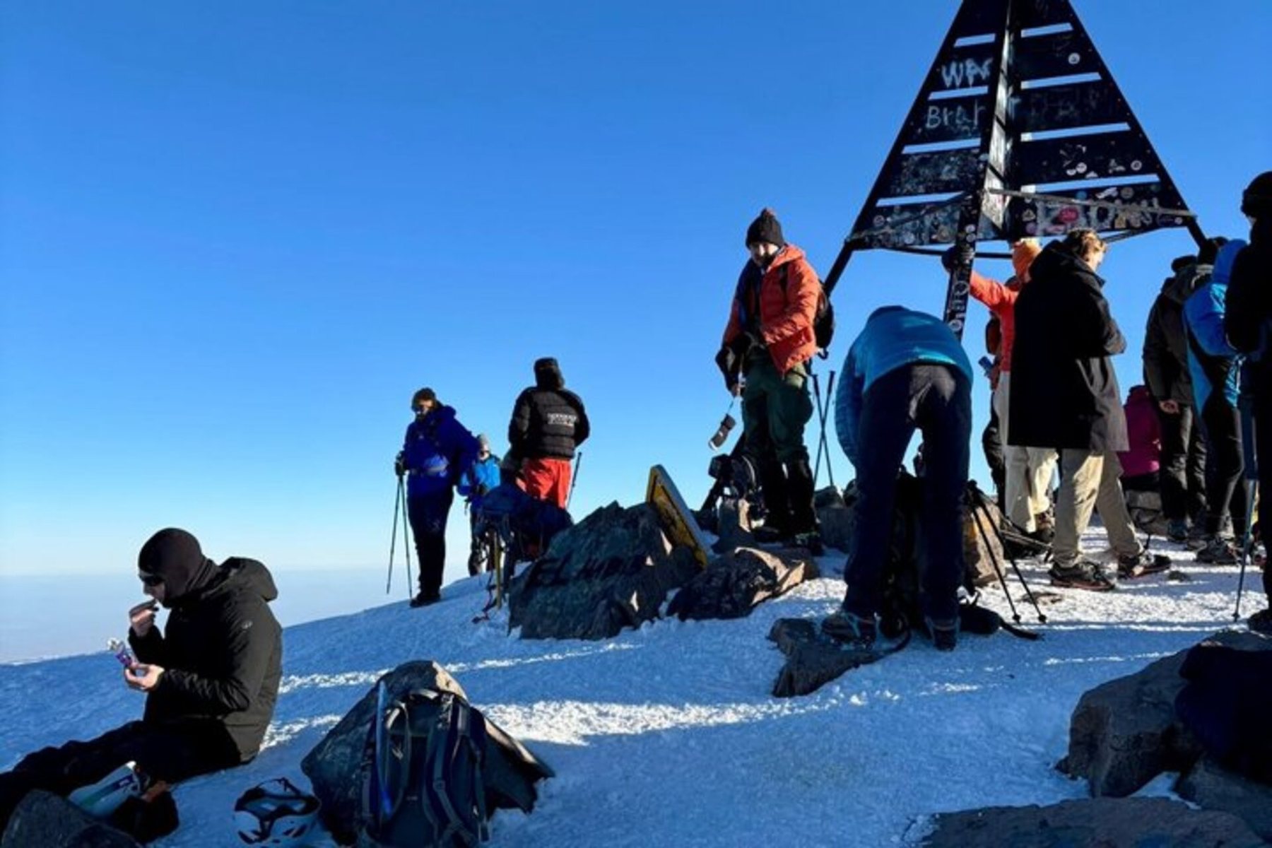 A group of climbers on a snowy summit